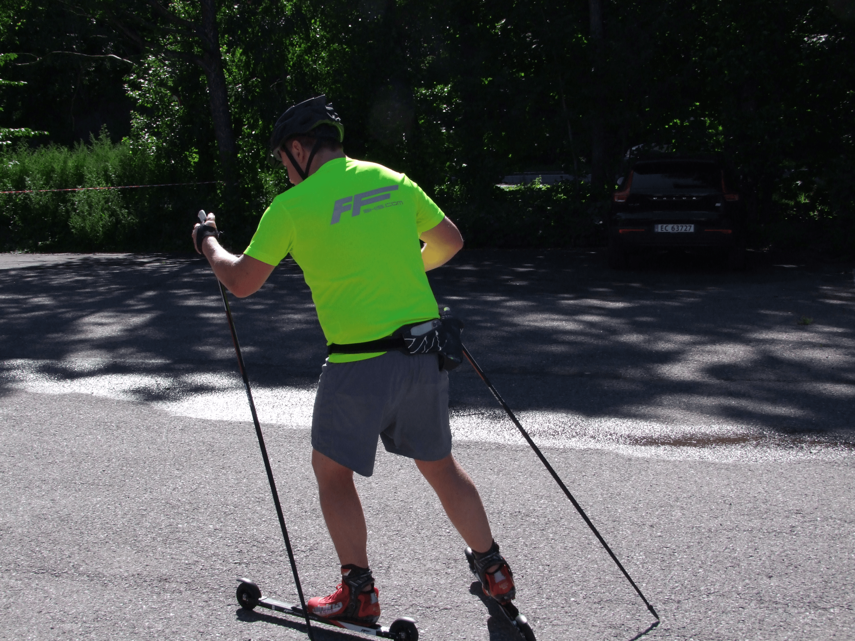A person roller skiing on a sunny day, showing the different techniques used in the sport