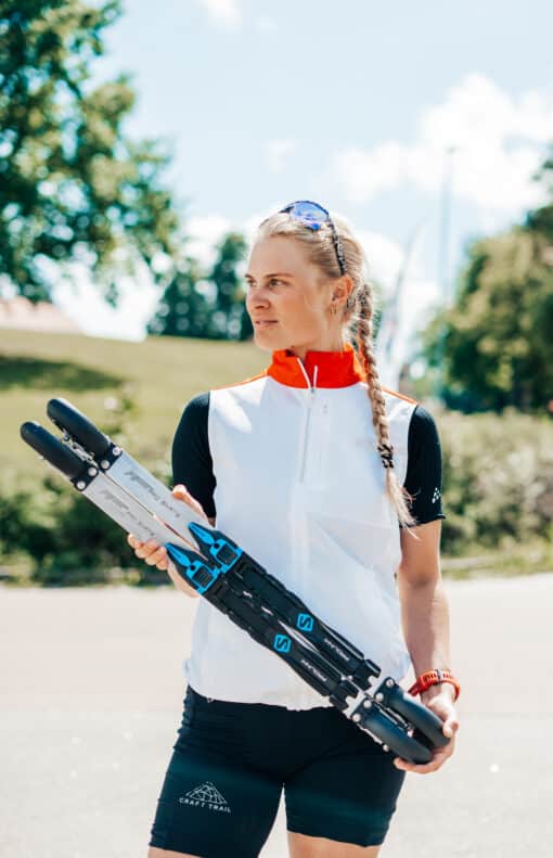 FF Rollerskis: Experience Summer Skiing Woman holding a pair of FF rollerskis outdoors.