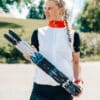 FF Rollerskis: Experience Summer Skiing Woman holding a pair of FF rollerskis outdoors.