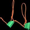 FF PoleControl - Master Your Rollerski Swing Green ff polecontroll clips with orange elastic bands for stabilizing rollerski pole backswing against a black background.