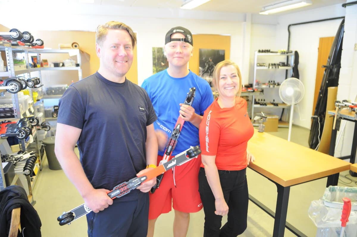 Henrik Tobias and Pernille smiling in the workshop while holding professional FF Rollerskis equipment.