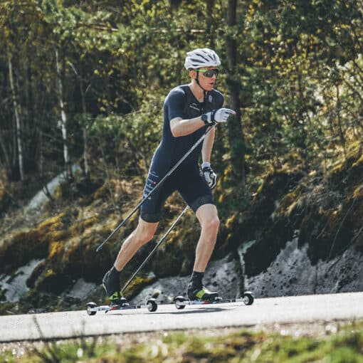 FF-V-Pro-Classic-Rollerskis-in-Action-on-Track Skier using FF V Pro Classic rollerskis on a track, showcasing stability and high performance.
