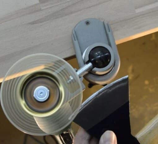 Close-up of a roller ski pole tip being sharpened with a diamond disc for better performance